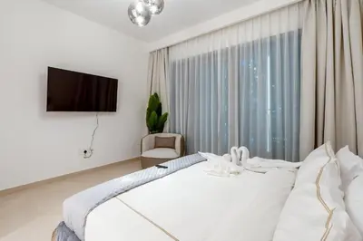 a bedroom with a white bed and a large window at 3 Bedrooms Apartment in Downtown Views - Dubai Burj Khalifa View in Dubai