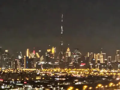 a view of a city at night with lights at Vacay Lettings -2 bed at Park ridge Dubai Hills in Dubai
