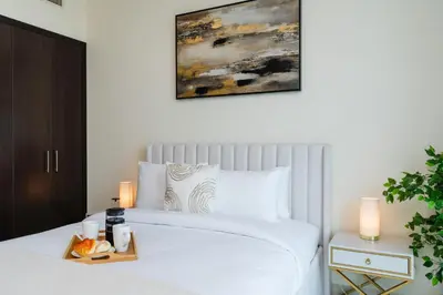 a bedroom with a bed with a tray of food on it at Classy Upgraded - High Floor - Prime Location in Dubai