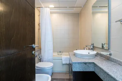 a bathroom with a sink and a toilet and a tub at Classy Upgraded - High Floor - Prime Location in Dubai