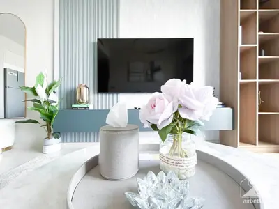 a living room with a vase of flowers on a table at Burj Royale Luxury One-Bedroom with City Views in Dubai