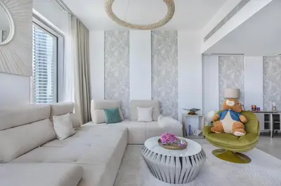 a living room with a couch and a table at Ultra-Luxury 2BR at La Vie Iconic Sea Views in Dubai