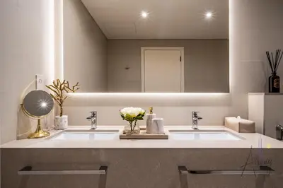 a bathroom with two sinks and a mirror at Ultra-Luxury 2BR at La Vie Iconic Sea Views in Dubai