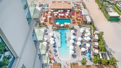 an overhead view of a pool at a resort at Ultra-Luxury 2BR at La Vie Iconic Sea Views in Dubai