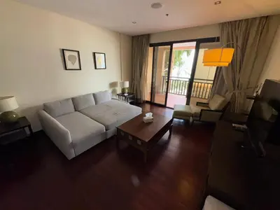 a living room with a white couch and a table at Royal Amwaj-Anantara residence South in Dubai