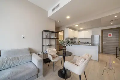 a living room with a couch and a table at Cityview Haven 1BR Modern Flat in Bloom Heights in Dubai