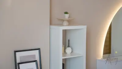 a room with two white shelves and a mirror at Cityview Haven 1BR Modern Flat in Bloom Heights in Dubai