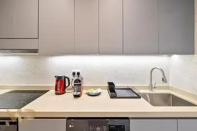 a kitchen counter with a coffee maker and a sink at Marcopolo - Experience luxury living with lake views in JLT in Dubai