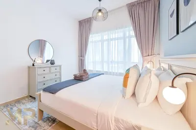 a bedroom with a large white bed with a window at Marcopolo - Experience luxury living with lake views in JLT in Dubai