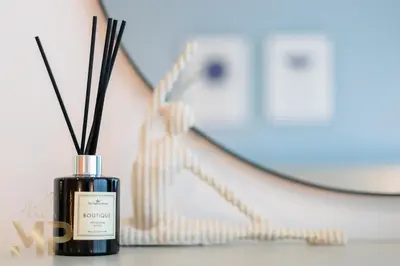 a bottle of perfume on a table next to a mirror at Marcopolo - Experience luxury living with lake views in JLT in Dubai