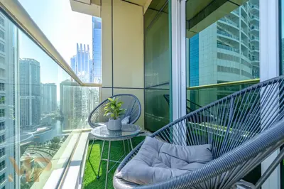 a balcony with a table and chairs on a building at Marcopolo - Experience luxury living with lake views in JLT in Dubai