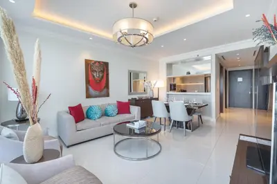 a living room with a couch and a table at Downtown Elegance - 1BR Apartment with Unmatched Burj Khalifa Views in Dubai
