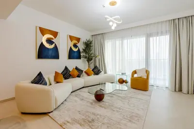 a white living room with a couch and a table at 3 Bedroom - Burj Khalifa View, Downtown Views II in Dubai