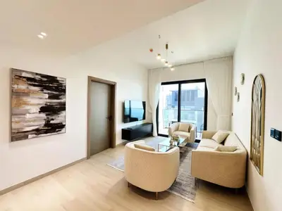 a living room with two chairs and a couch and a table at Binghatti Heights JVC in Dubai
