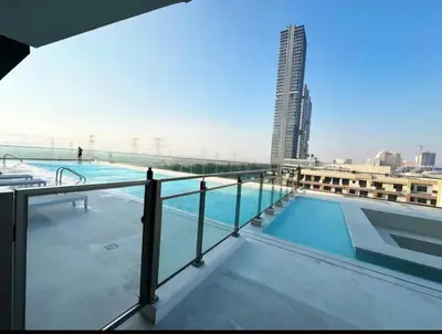 a swimming pool on the roof of a building at Binghatti Heights JVC in Dubai