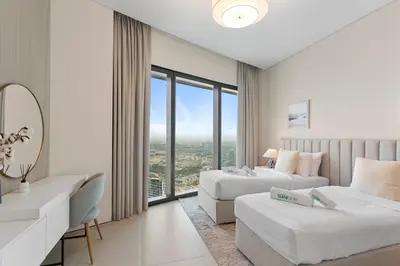 a hotel room with two beds and a large window at Exceptional high floor 3bed apartment by Suiteable in Dubai