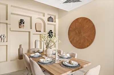 a dining room with a wooden table and chairs at Stunning Waterfront Burj Views with Pool & Gym, Sleeps 6 in Dubai