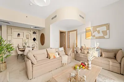 a living room with two couches and a table at Stunning Waterfront Burj Views with Pool & Gym, Sleeps 6 in Dubai
