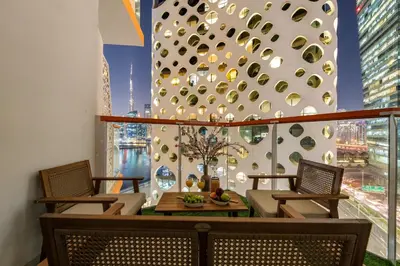 a room with chairs and a table and a window at Stunning Waterfront Burj Views with Pool & Gym, Sleeps 6 in Dubai