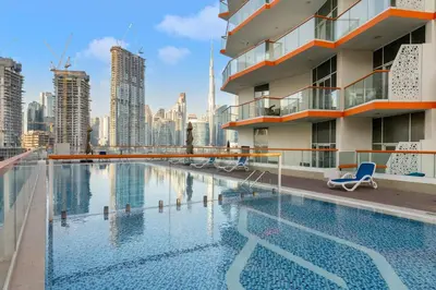 a swimming pool on the roof of a building with a city skyline at Stunning Waterfront Burj Views with Pool & Gym, Sleeps 6 in Dubai