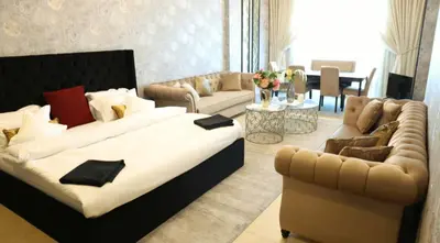 a living room with a large bed and a couch at Luxury Apartment by oima leasing property in Dubai