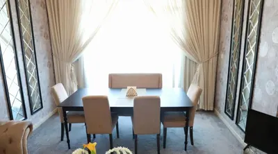 a dining room with a table and chairs at Luxury Apartment by oima leasing property in Dubai