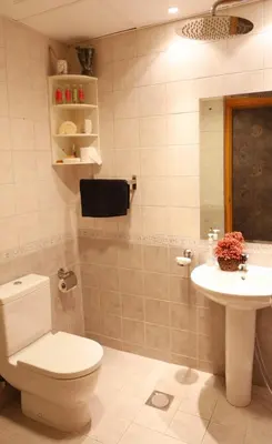 a bathroom with a toilet and a sink at Luxury Apartment by oima leasing property in Dubai