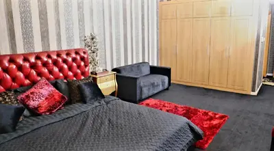 a bedroom with a bed and a couch and a chair at Royal Classic by oima leasing property in Dubai