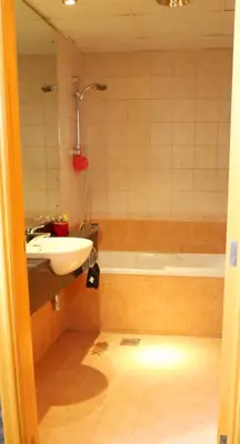 a bathroom with a sink and a bath tub at Royal Classic by oima leasing property in Dubai