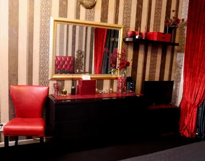 a room with a mirror and a red chair at Royal Classic by oima leasing property in Dubai