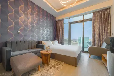 a hotel room with a bed and a couch at Creek view studio deleguest in Dubai