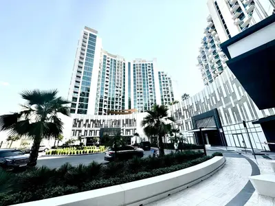 a street in a city with tall buildings and palm trees at Creek view studio deleguest in Dubai