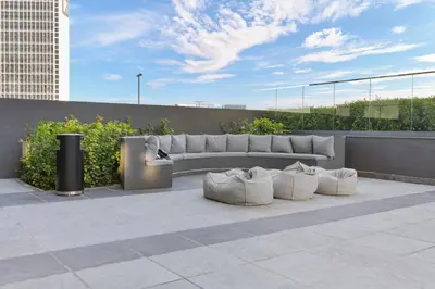 a bench sitting on top of a building at Waves - Spacious 2BR Apartment with Burj Views & Terrace in Dubai