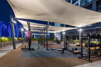 a fitness room with a gym with weights at Waves - Spacious 2BR Apartment with Burj Views & Terrace in Dubai