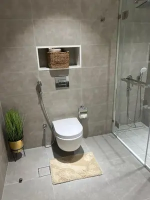 a bathroom with a toilet and a shower at 2 Bedrooms - District One Residences 13 in Dubai