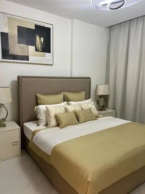 a bedroom with a large bed with two night stands at 2 Bedrooms - District One Residences 13 in Dubai