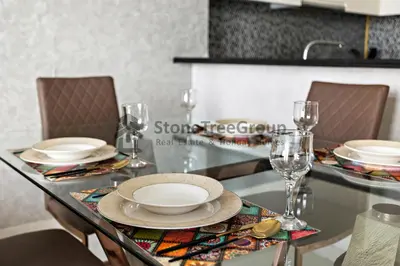 a dining room table with plates and glasses on it at Stonetree - Spacious 2BR in Paramount in Dubai