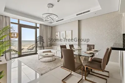 a living room with a table and a couch at Stonetree - Spacious 2BR in Paramount in Dubai