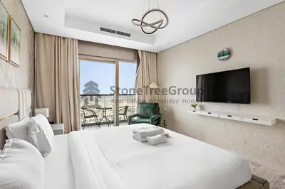 a hotel room with a bed and a tv at Stonetree - Spacious 2BR in Paramount in Dubai