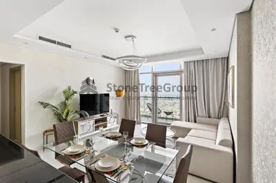 a living room with a dining table and a couch at Stonetree - Spacious 2BR in Paramount in Dubai