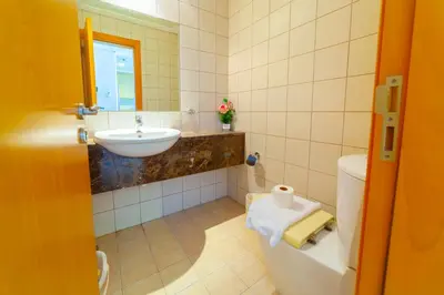 a bathroom with a sink and a toilet at An Elegant Fully Furnished 1 Bedroom Apartment in Clayton Residency, Business Bay, Dubai in Dubai