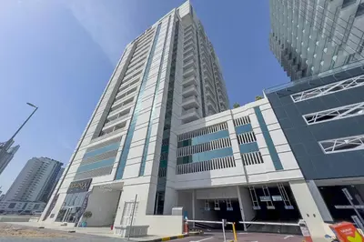 a tall white building with a lot of windows at An Elegant Fully Furnished 1 Bedroom Apartment in Clayton Residency, Business Bay, Dubai in Dubai