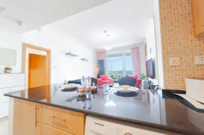 a kitchen with a large island in a room at An Elegant Fully Furnished 1 Bedroom Apartment in Clayton Residency, Business Bay, Dubai in Dubai