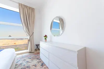a bedroom with a white dresser and a mirror at An Elegant Fully Furnished 1 Bedroom Apartment in Clayton Residency, Business Bay, Dubai in Dubai