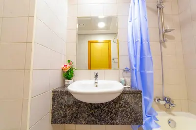 a bathroom with a sink and a mirror at An Elegant Fully Furnished 1 Bedroom Apartment in Clayton Residency, Business Bay, Dubai in Dubai