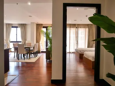 a bedroom with a bed and a dining room at Waterfront 2BR Apartment with Sea Views in Dubai