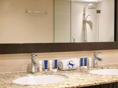 a bathroom counter with two sinks and a mirror at Waterfront 2BR Apartment with Sea Views in Dubai