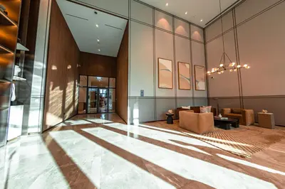 a lobby of a building with chairs and a table at Grande Signature Residence, Burj Khalifa and Fountain View in Dubai