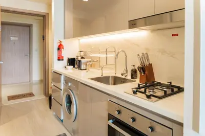a kitchen with a sink and a washing machine at Studio next Dubai Mall with pool in Dubai