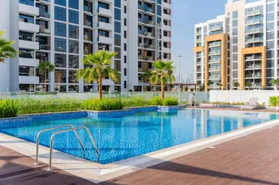 a swimming pool with palm trees and buildings at Studio next Dubai Mall with pool in Dubai